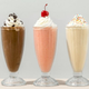 Chocolate, strawberry, and vanilla milkshake on counter